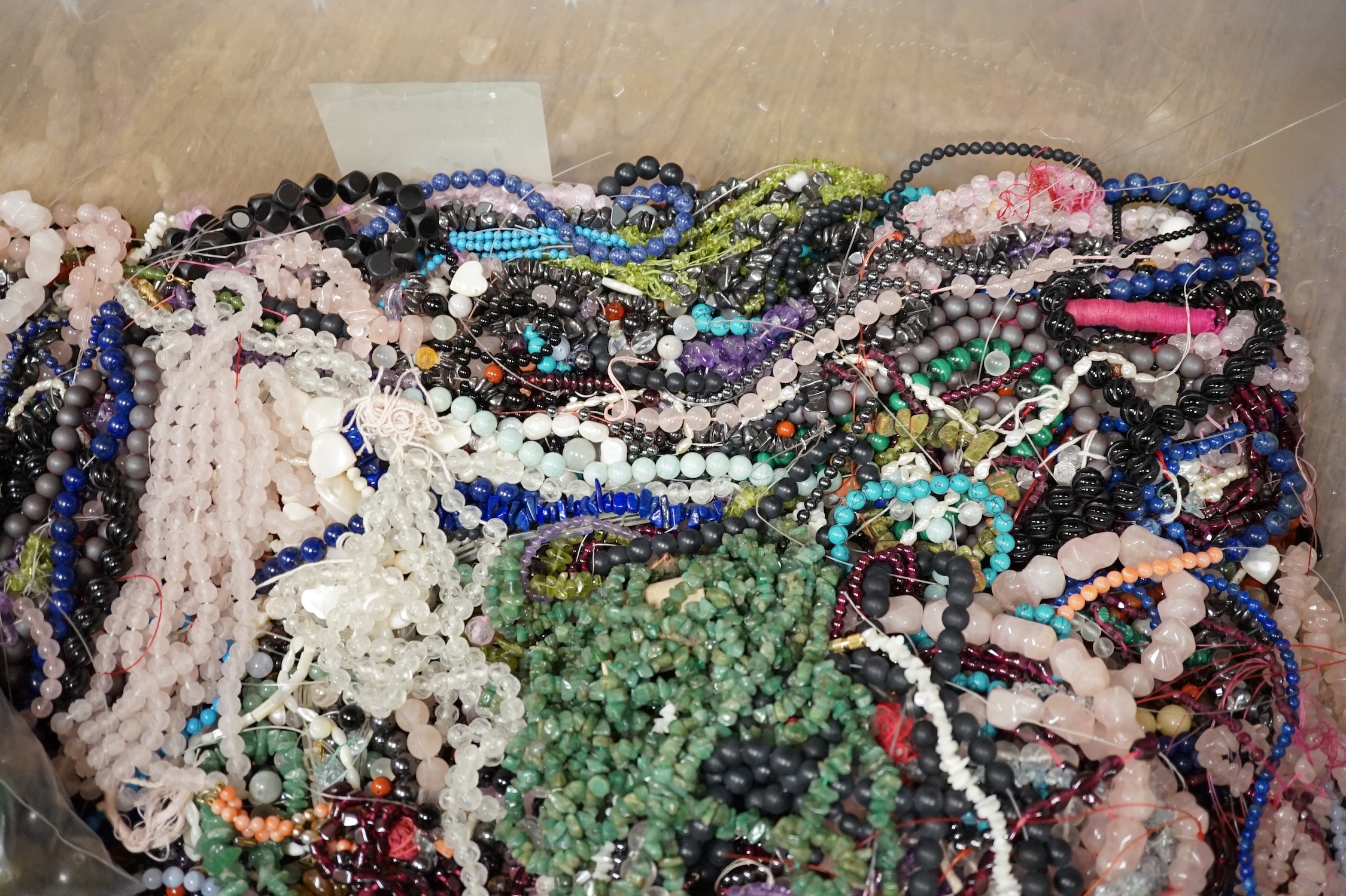 A large collection of in excess of three hundred bead necklaces and bracelets and a quantity of hardstone beads. Condition - poor to fair